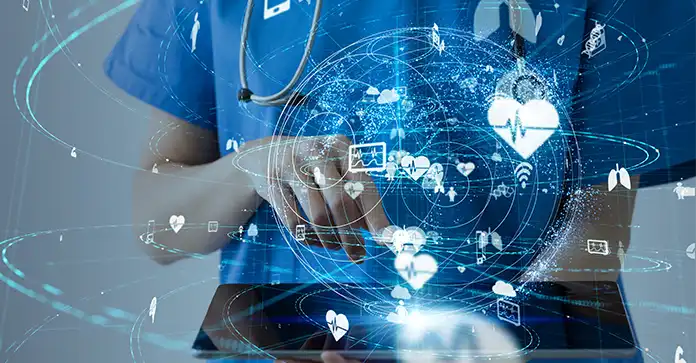 Nurse in scrubs holds ipad with connected graphics representing healthcare